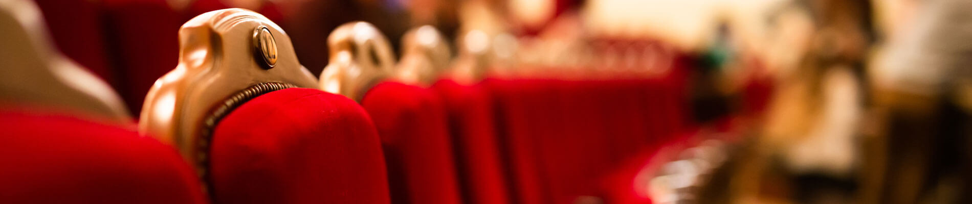 Red Velvet Armchairs In An Empty Theater Hall